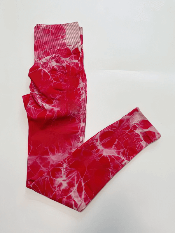 Vibrant red seamless women's leggings with push-up effect, featuring a stylish marble pattern. Perfect high-waisted, ankle-length fit.